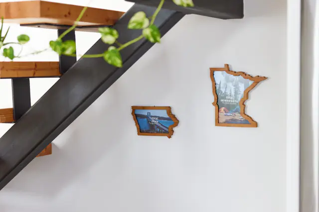 Iowa and Minnesota Borderframes on the wall beside a staircase